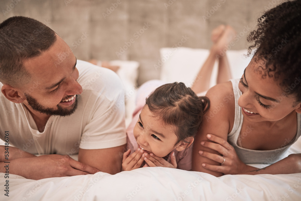 Fototapeta premium Mother, father and girl in bed in house bedroom, home interior and bonding on a morning. Family smile, happy and love bond parents or man and woman with young child in security, support or trust
