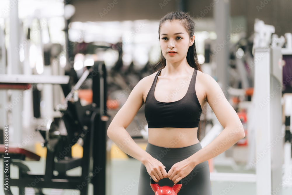 Asian female fitness athlete in gym