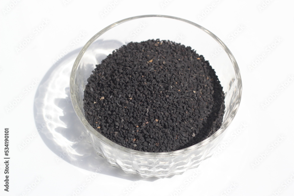 Black cumin seeds on a white background, black cumin seeds on a bowl Black cumin seeds on a white background, black cumin seeds on a bowl
