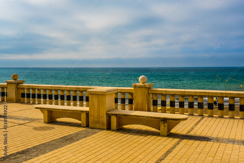 Empty benches on the beach, Sitges, Catalonia
