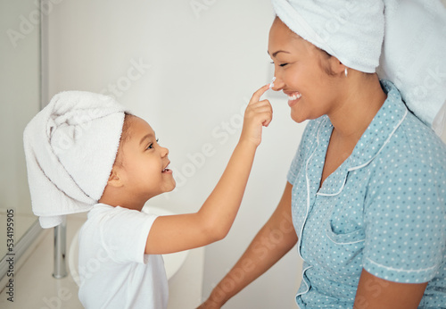 Mother, face cream and girl child in bathroom apply beauty, cosmetics and lotion product for shower morning routine. Happiness, smile or happy mom and young kid love skincare creme, bonding at home