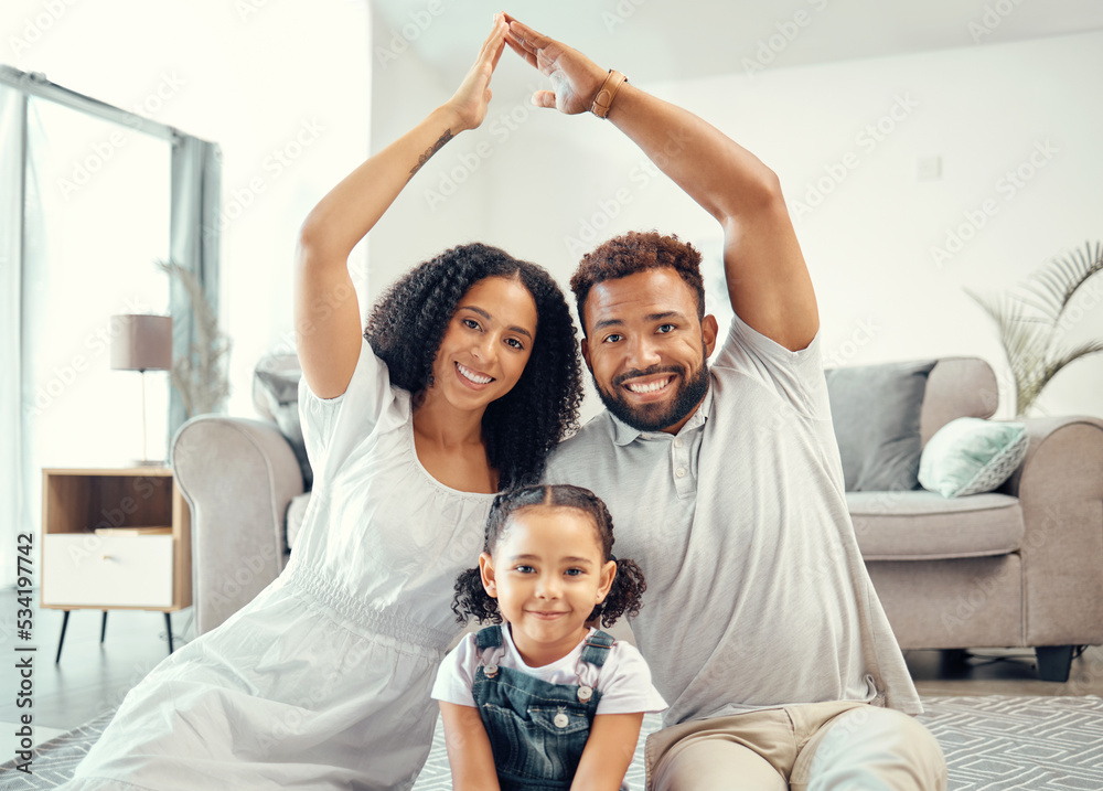 Protection, smile and portrait of family with a roof or covering hand gesture sitting on the living room floor. Happy, safety and home insurance of parents with girl child at a modern home together.