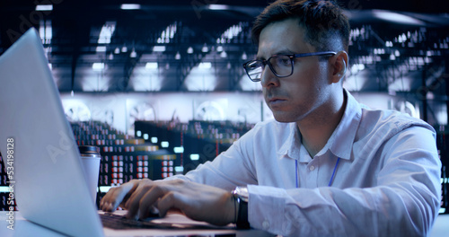 Caucasian Male, IT Technician Use Laptop, Do Maintenance and Diagnostics in the Server Room. Cloud Storage Technology, Database, Engineering