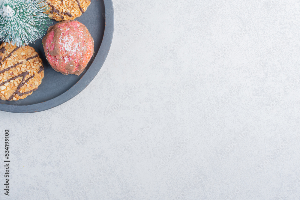 Small tray of cookies with a tree figurine on marble background Small tray of cookies with a tree figurine on marble background