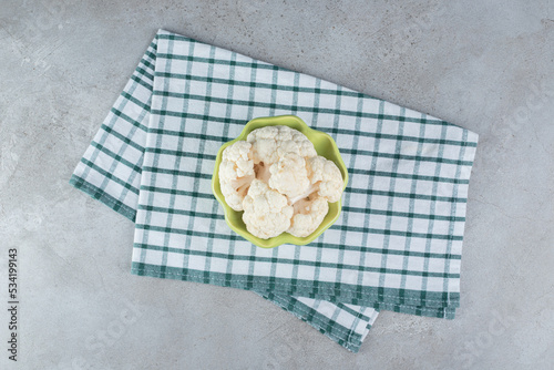 Uncooked fresh cauliflower vegetable on a tablecloth