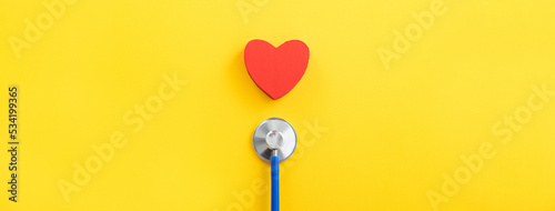 Foto Blue stethoscope with red heart, medical care design concept.