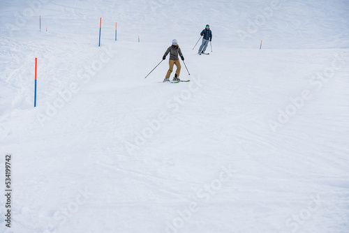 Young people skiing in snow high mountains on winter day - Holiday vacations and winter lifestyle concept