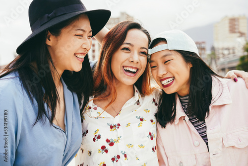 Asian friends having fun together outdoor - Focus on center girl face