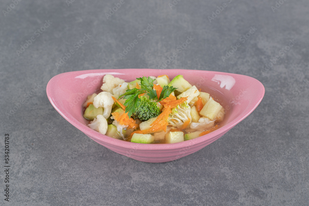 Slices of fresh vegetables in pink bowl Slices of fresh vegetables in pink bowl