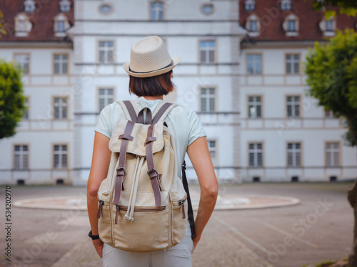 Woman having a great vacation in Switzerland, Delemont. Lady visiting tourist attractions and landmarks. Delemont Castle