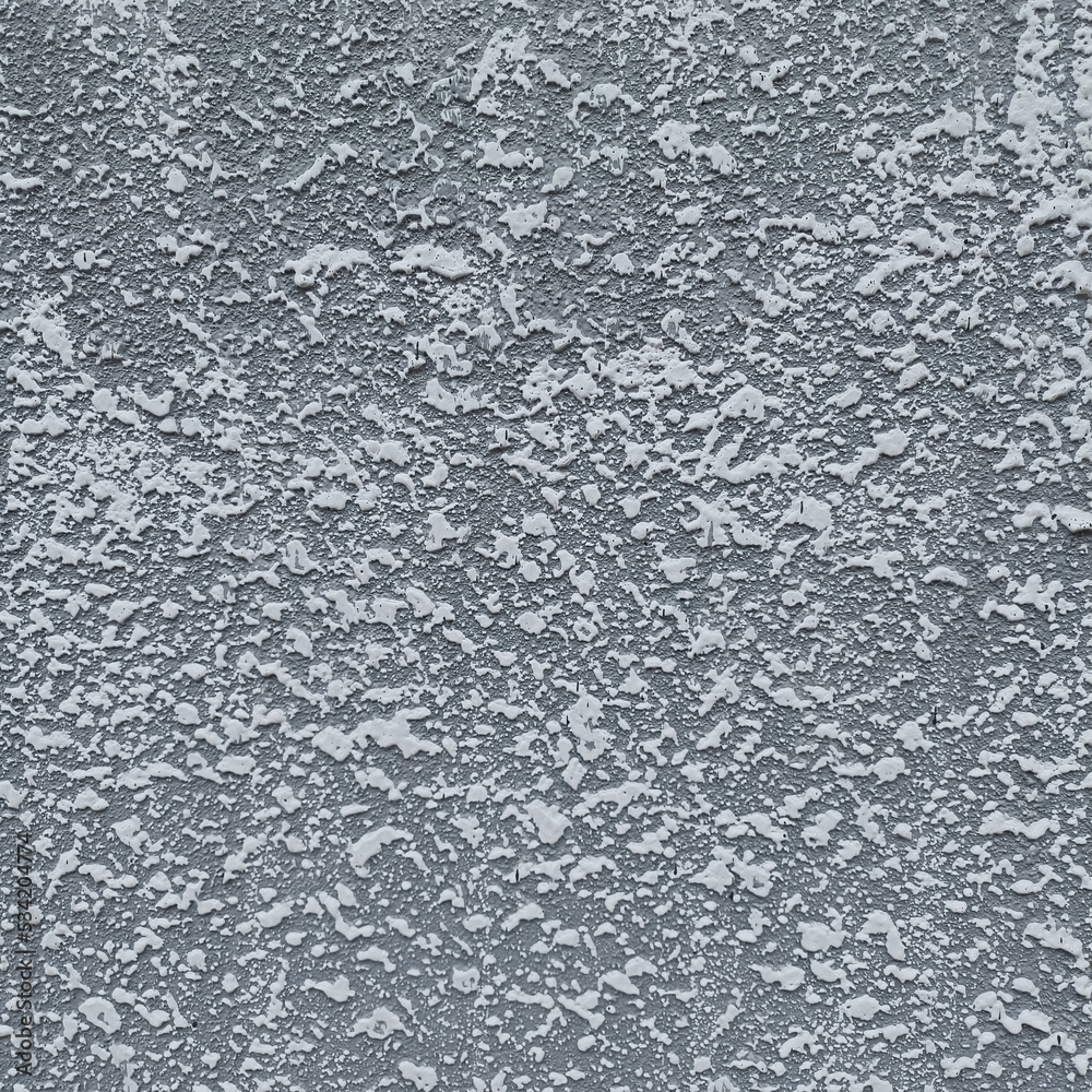The gray plaster wall is painted in reliefs as white dots exposed by the afternoon sunlight. The gray plaster wall is painted in reliefs as white dots exposed by the afternoon sunlight.