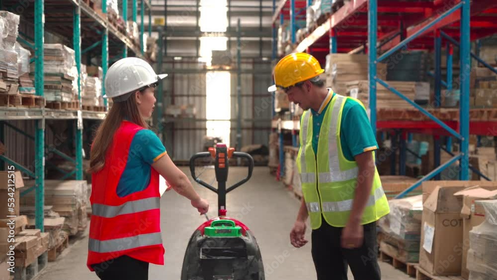 Asian female employee inspects the documents in her hand and instructs