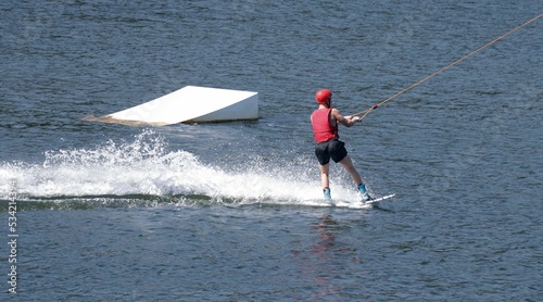 Person water-skiing on a lake in Niedersfeld, Germany photo