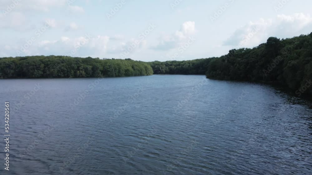 Trémelin or Tremelin lake and surrounding forest, Brittany in France. Aerial drone forward and tilt down Trémelin or Tremelin lake and surrounding forest, Brittany in France. Aerial drone forward and tilt down