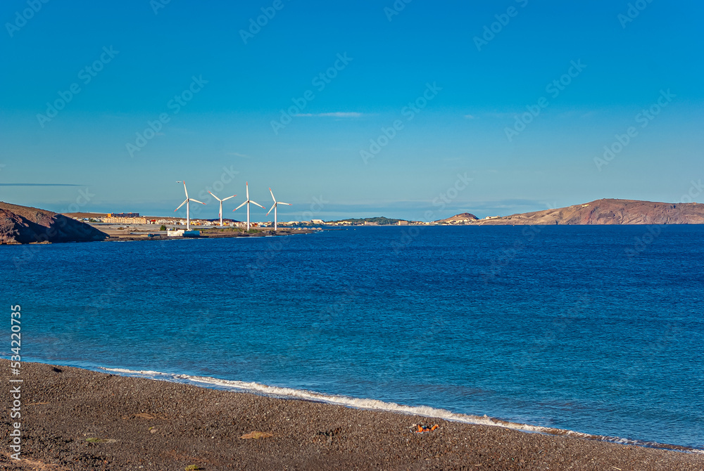 Four wind turbines on the coast of the Canary Islands, Spain. Alternative energy.