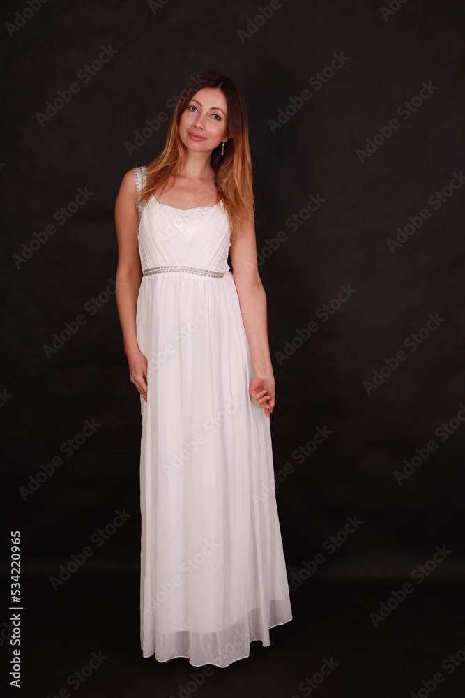 Full length portrait of beautiful woman in white dress on black background Full length portrait of beautiful woman in white dress on black background