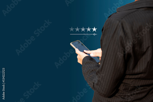 Fototapeta Naklejka Na Ścianę i Meble -  Concept of satisfaction, quality and performance of services. Woman who gives leave feedback on the bought product with five star rating feedback.