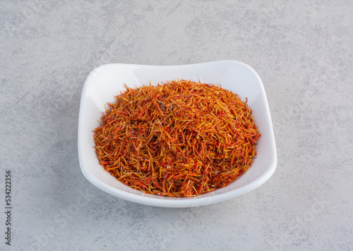 Saffron seeds in a white ceramic bowl