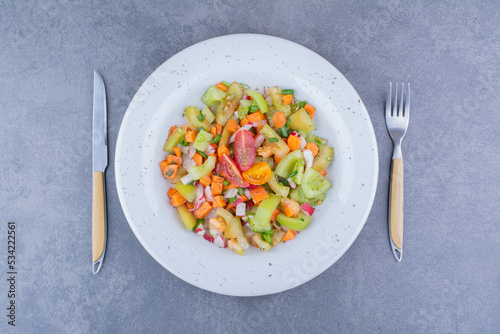 Salad with green vegetable and cherry tomatoes in ceramic dishes