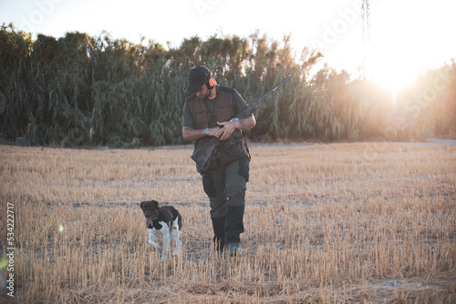 A young hunter walks with his dog in search of animals.hunting season.