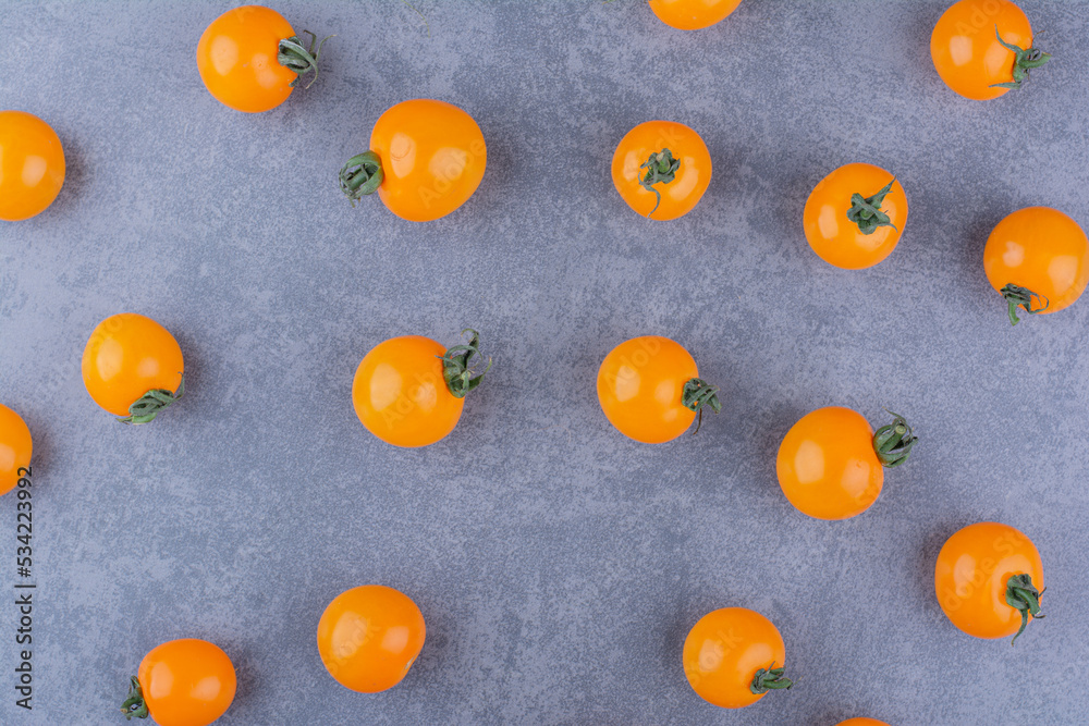 Yellow cherry tomatoes isolated on blue background Yellow cherry tomatoes isolated on blue background