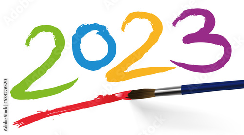 Concept artistique pour une carte de voeux, avec l’année 2023 écrite de différente couleurs avec un pinceau, sur un fond blanc. photo