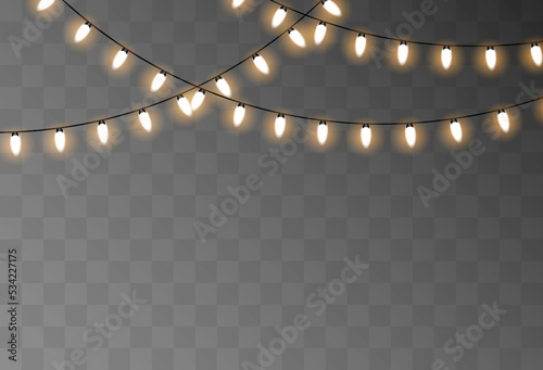 Glowing light bulbs of different sizes isolated on a transparent background. Vector seamless horizontal border of realistic yellow light garlands. Festive decoration with shiny Christmas lights.