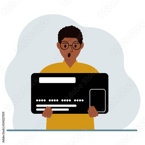 A man holds a large credit card in his hands.