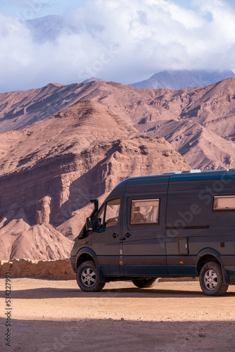 Campervan 4x4 in a route with red mountains at La Quebrada las Conchas in Argentina. © JoseMaria