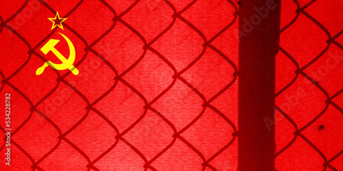 Backlight Backlight with physical Soviet flag and barbed wire. Prison concept with border image. Double exposure hologram.