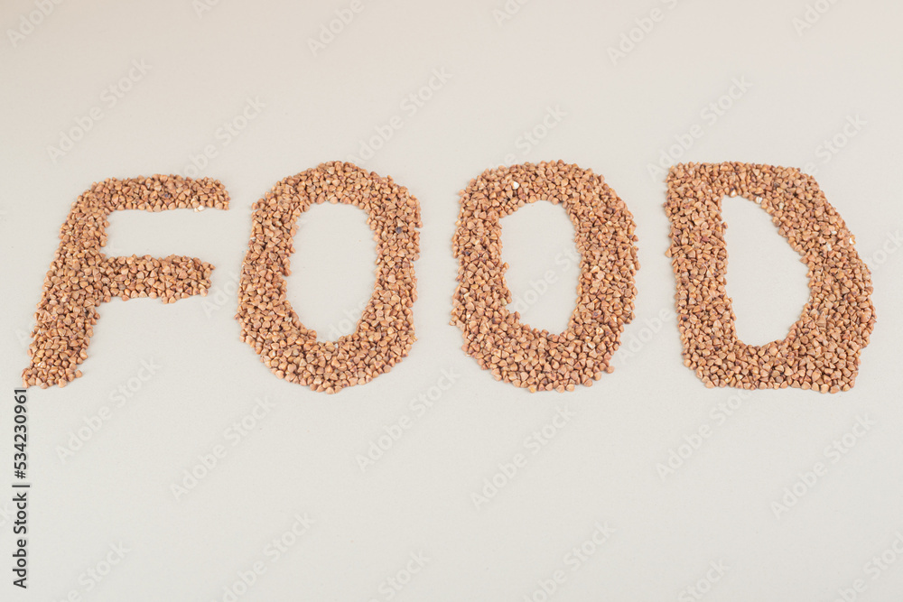 Writing on a concrete background with brown beans Writing on a concrete background with brown beans