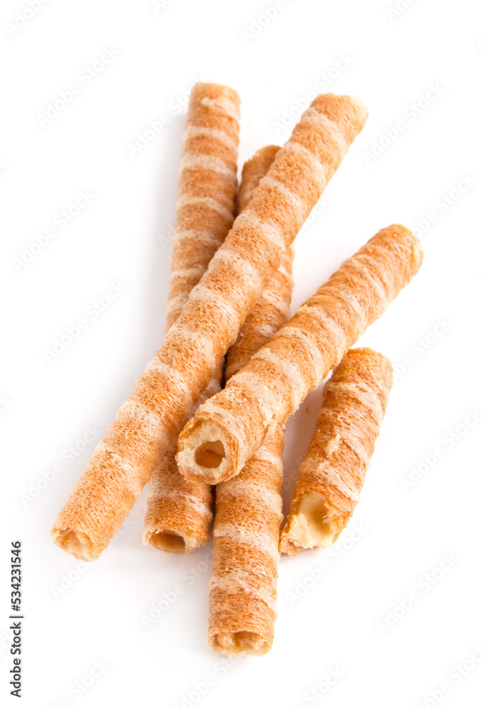Sweet waffle tubules with a vanilla cream on the white background Sweet waffle tubules with a vanilla cream on the white background