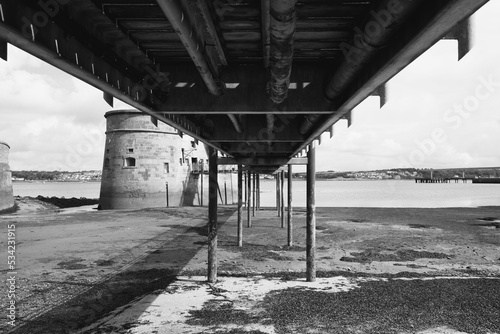 Grayscale shot under the metal walkway to the James Joyce Tower and Museum in Dublin, Ireland photo