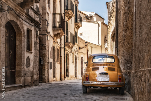 Old yellow Fiat 500 in the city centre of Syracuse in Sicily, Italy © Ron van der Stappen