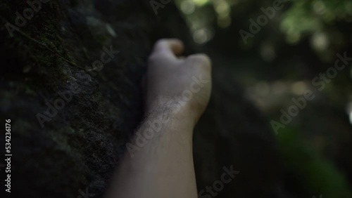 close up man touching with his hand a tree in the forest in kaiate falls. slow motion photo