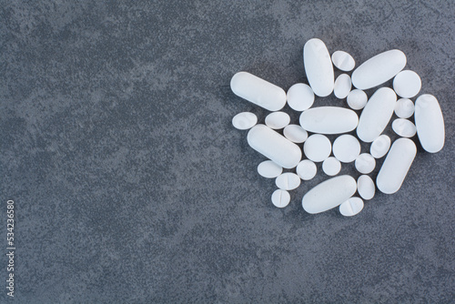 White medical pills on marble background