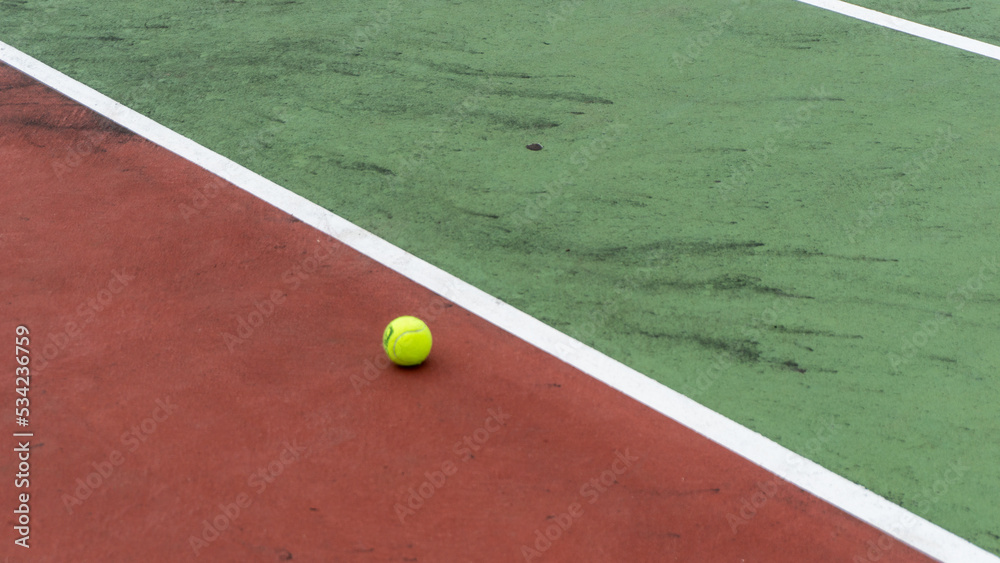 directly above shot of tennis court and yellow tennis ball