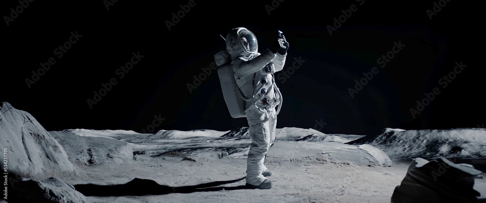 Astronaut searching for cellular or wi-fi signal while walking on Moon surface - obrazy, fototapety, plakaty 