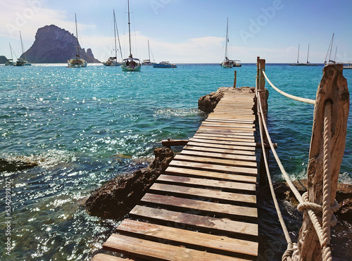 Pontile di legno a Cala d'Hort con vista su Es Vedrà, Ibiza photo