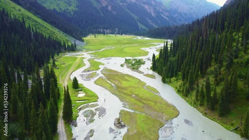 Aerial drone filmed beautiful mountains with a winding river flowing in the mountains of Kyrgyzstan, Karakol gorge near Issykul lake photo