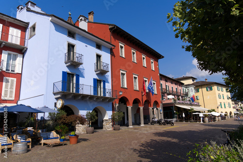 Red town hall at village of Ascona, Canton Ticino, with colorful houses on a sunny summer day. Photo taken July 24th, 2022, Ascona, Switzerland. © Michael Derrer Fuchs