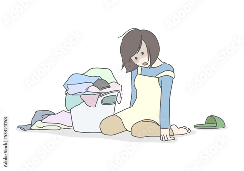 山積みの洗濯物と家事に疲れ果てたお母さん　洗濯物　立てない　ぐったり　へとへと