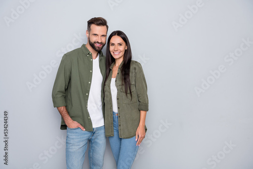 Portrait of attractive cheerful couple spouses hugging romance mood isolated over grey pastel color background