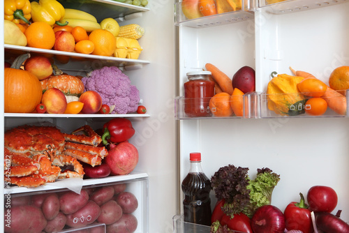 Content of open refrigerator. Color diet. Organic food, fruits, vegetables. Rainbow food in fridge, refrigerator. Healthy, dietary nutrition. Multicolored nutrition. Products in refrigerator, freezer