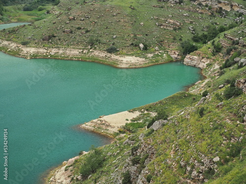 Natural monument, mountain lake Gizhgit with deep green water. Elbrus region, Kabardino-Balkarian Republic, Russia.