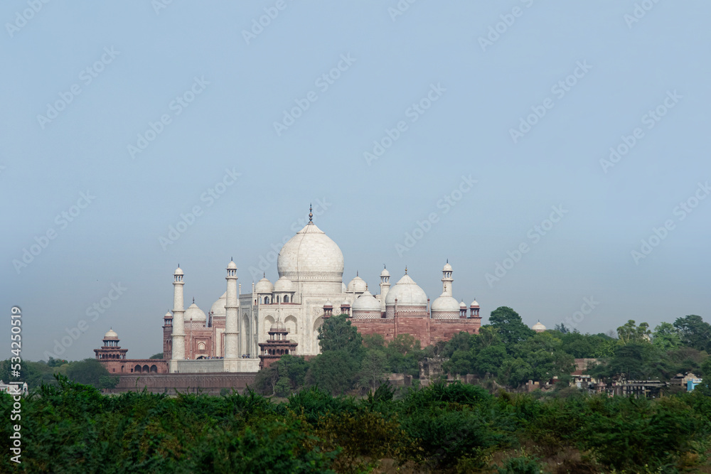 Taj Mahal on a bright clear day. Mosque for lover in city of Agra, Uttar Pradesh, INDIA. The most famous landmark of INDIA. The Taj Mahal  lovely marble white building. Layout for magazine, ads..