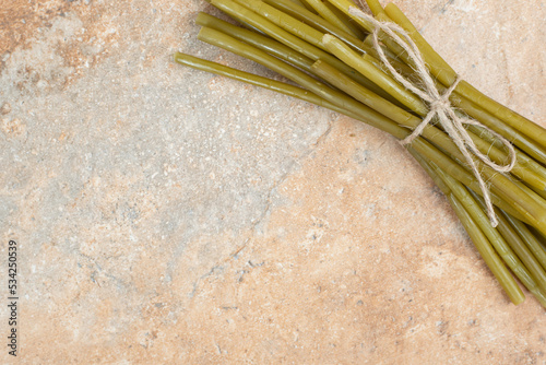 Pickled green beans on marble background