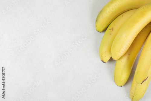 Bunch of yellow bananas on gray background