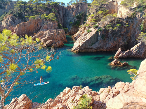 View of the sea from the cliff. Paddle surfing in S'Agaró, Mediterranean Sea, Costa Brava, Spain, Europe