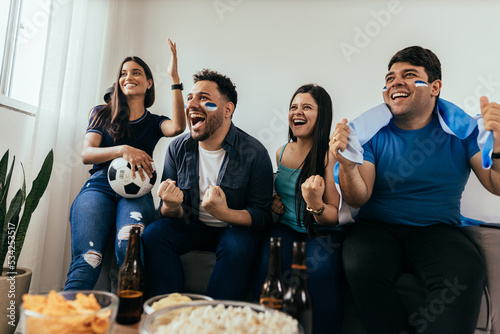 Cuadro en lienzo Football fans friends watching Argentina national team in live soccer match on T